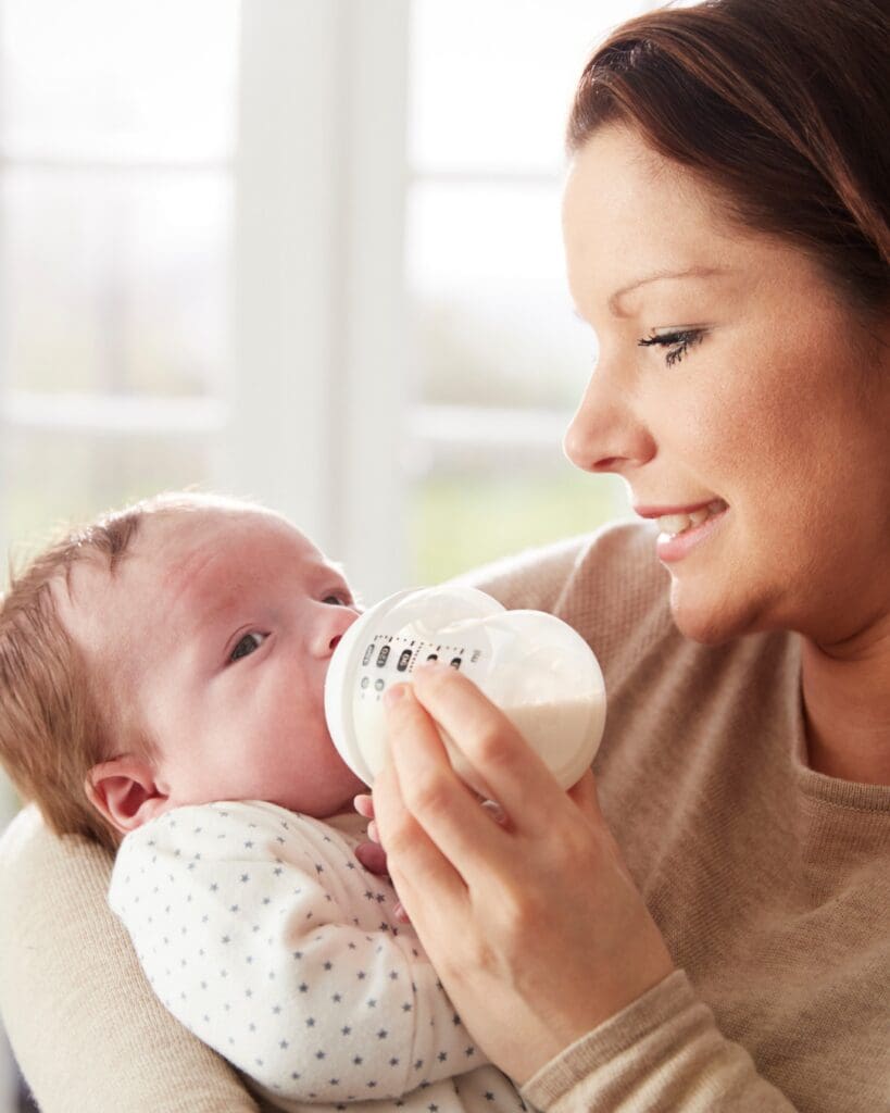 Mum Bottle feeding a breastfed baby