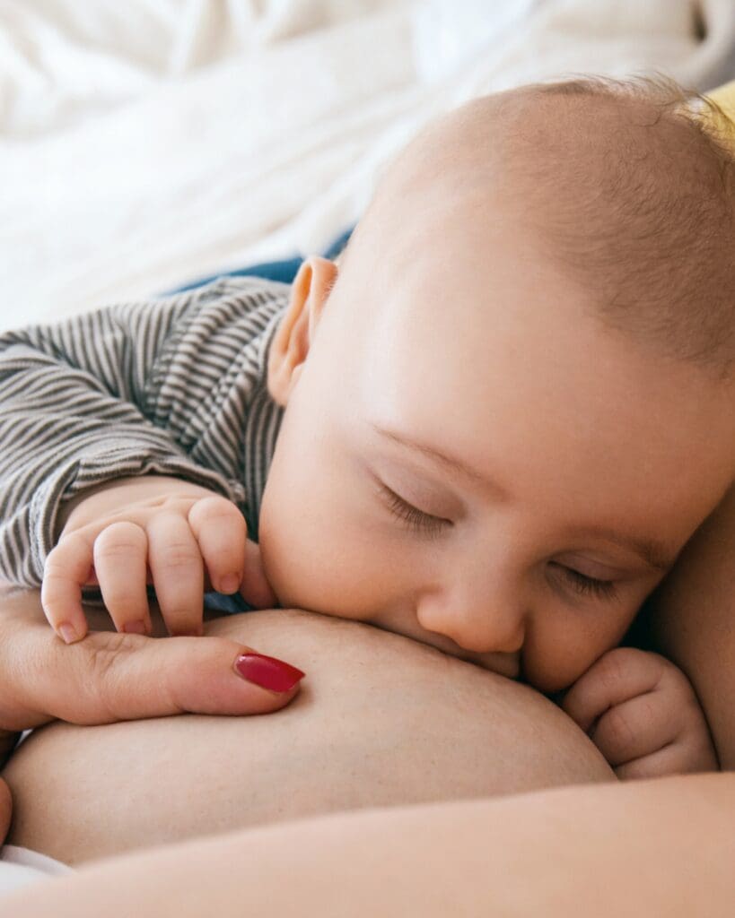 baby latched at the breast sleeping