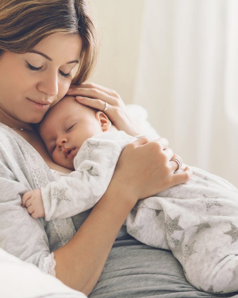 baby asleep on mums chest