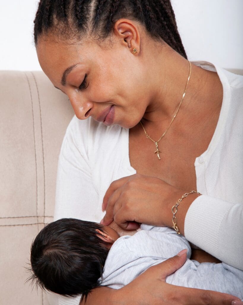 Happy Mum breastfeeding baby pain free