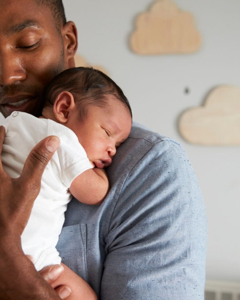 newborn baby having a cuddle with dad